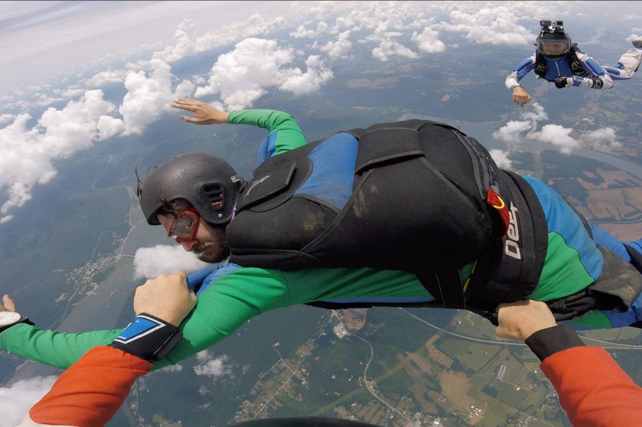 Man participating in hands on AFF training with the skydiving company instructors