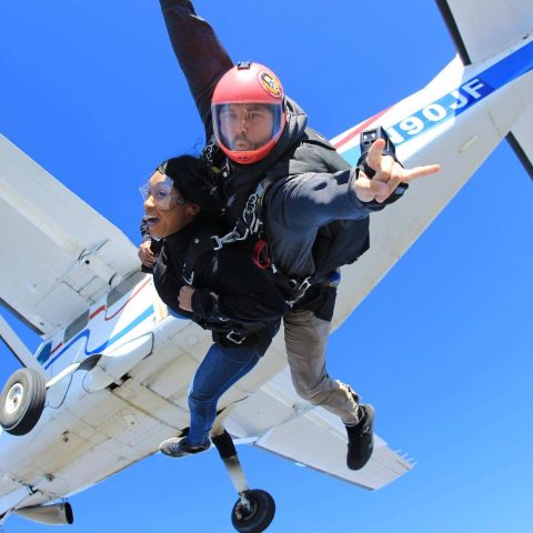 Tandem instructor experiencing the rush of free fall with student after leaping from the skydiving company aircraft