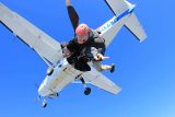 Tandem instructor experiencing the rush of free fall with student after leaping from the skydiving company aircraft