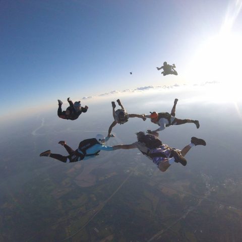 Experienced jumpers coming into formation during free fall at the skydiving company